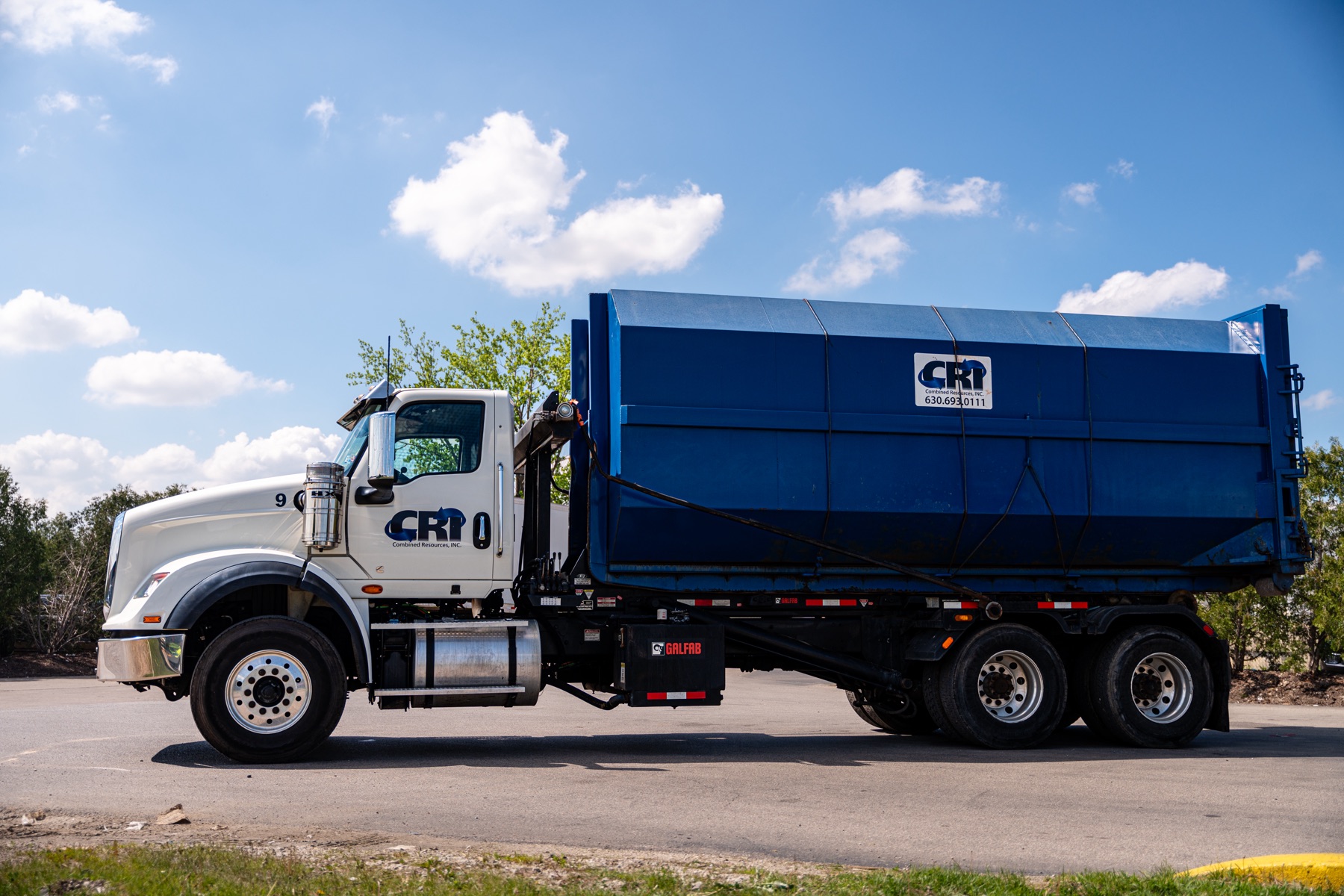 CRI truck with fully enclosed roll-off dumpster
